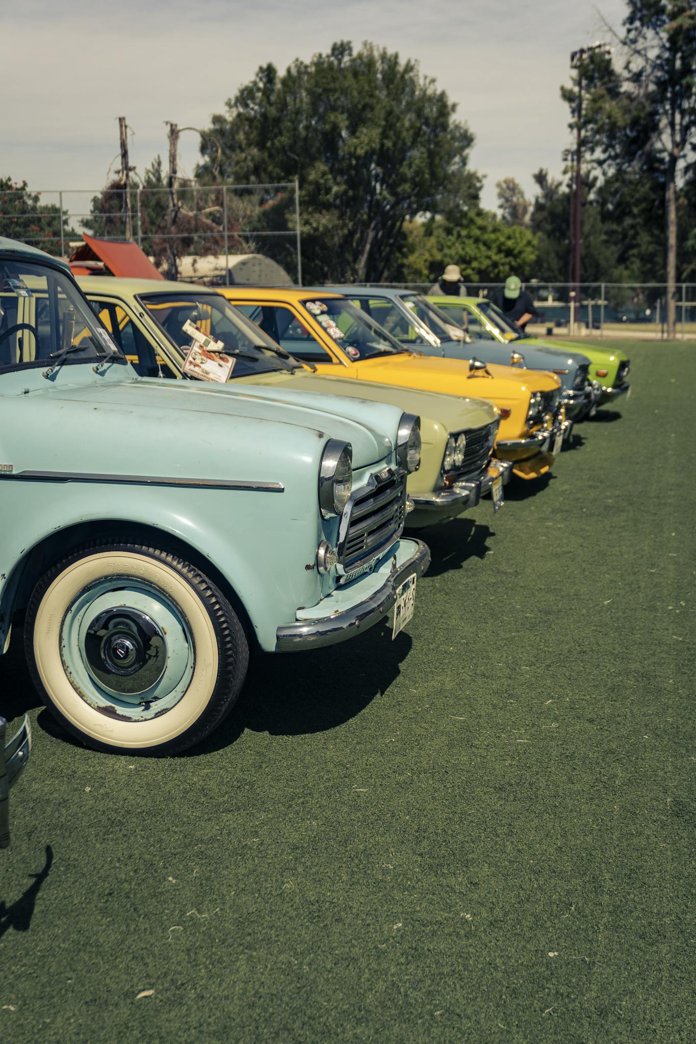 An array of vintage cars showcased outdoors in Zapopan, Mexico, under a sunny sky.